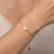 Armband in edelstaal, hartje met blauwe kralen