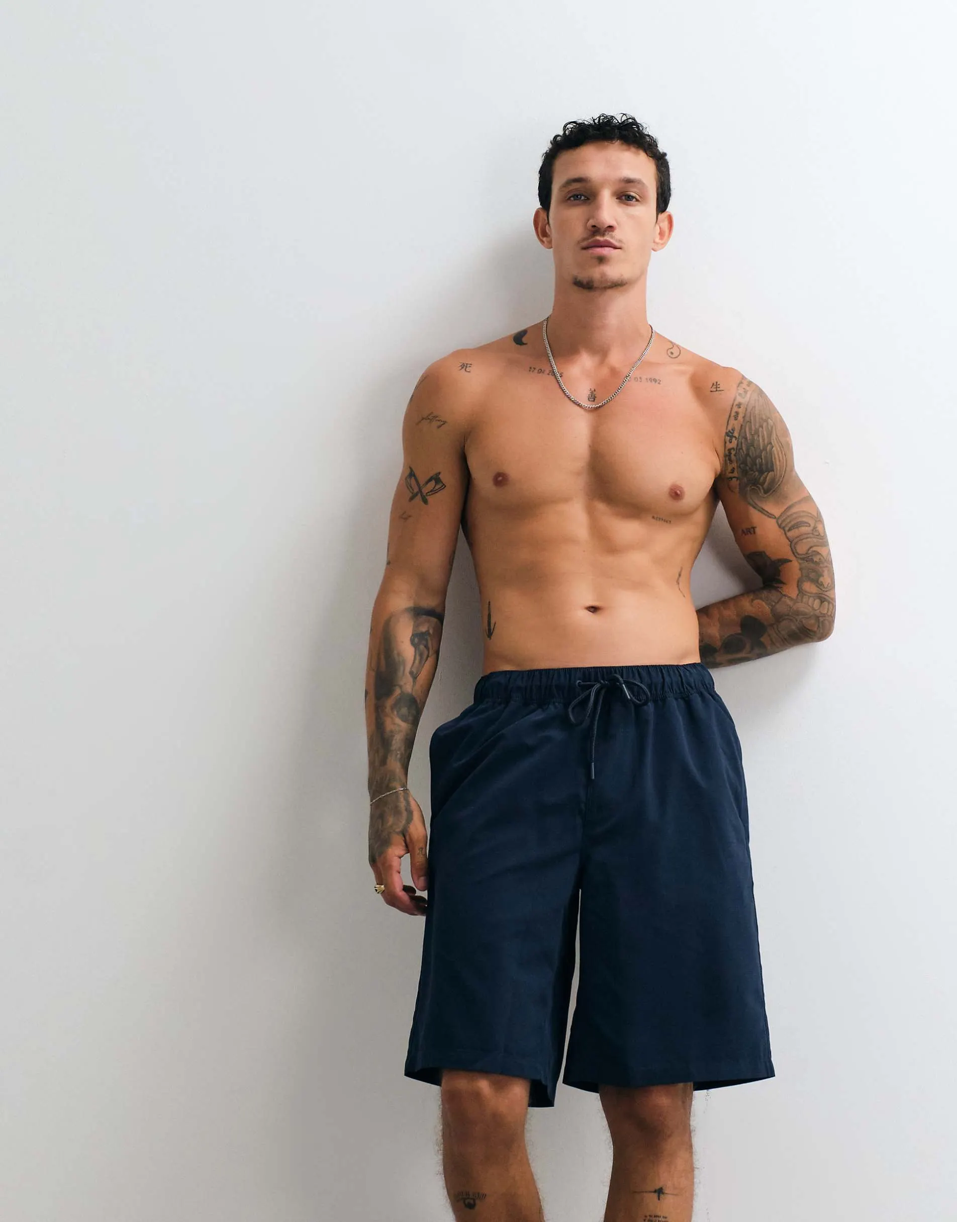 ASOS DESIGN swim shorts in long length in navy
