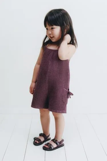 WAFFLE-KNIT SHORT JUMPSUIT WITH BOWS