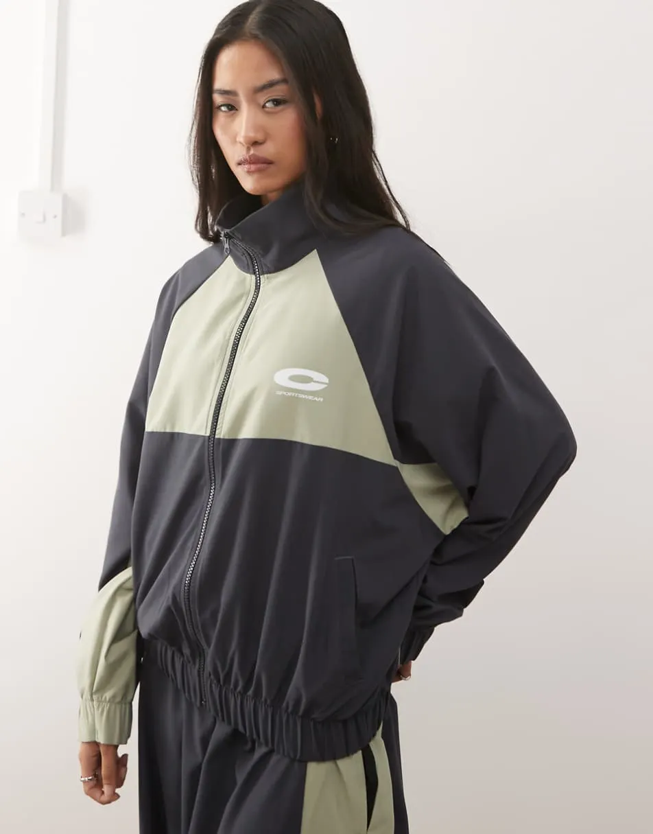 COLLUSION nylon sports funnel neck jacket co-ord in black and khaki