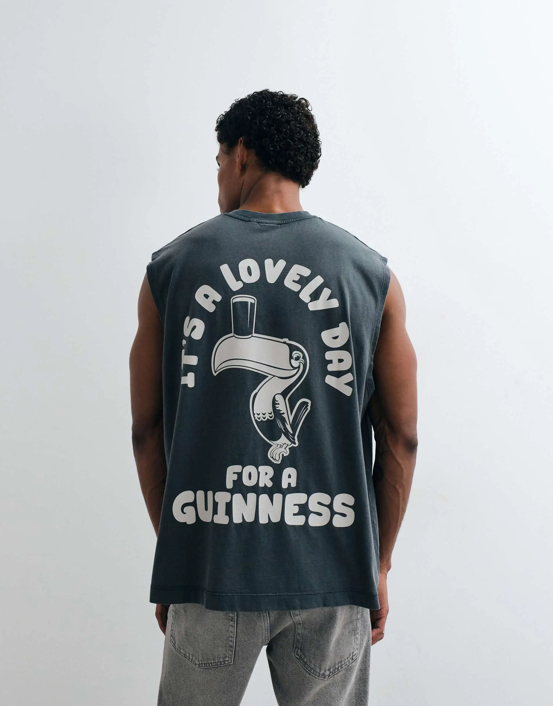 ASOS DESIGN oversized tank with Guinness print in Washed Black