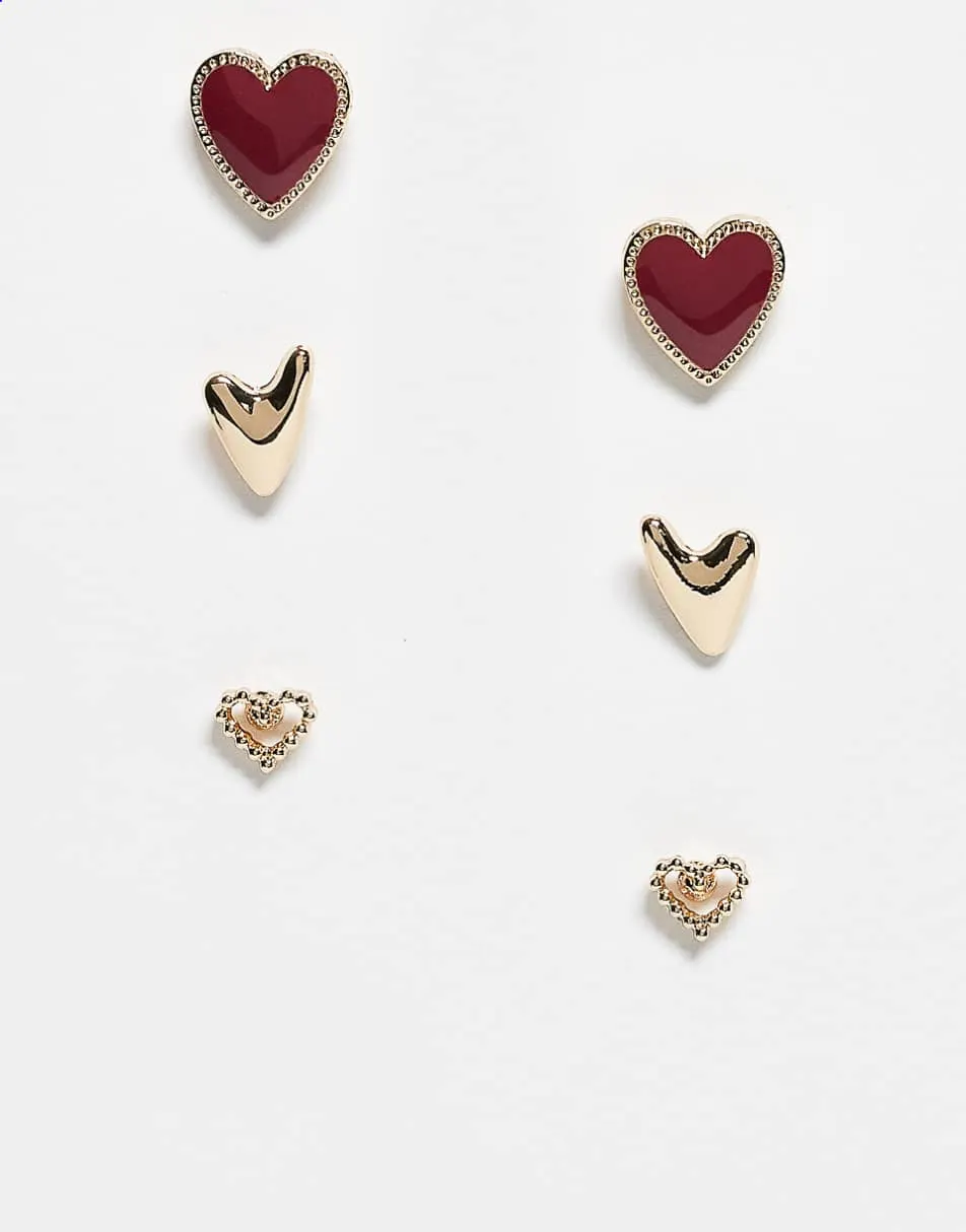 ASOS DESIGN 3 pack of stud earrings with heart design in gold and burgundy enamel