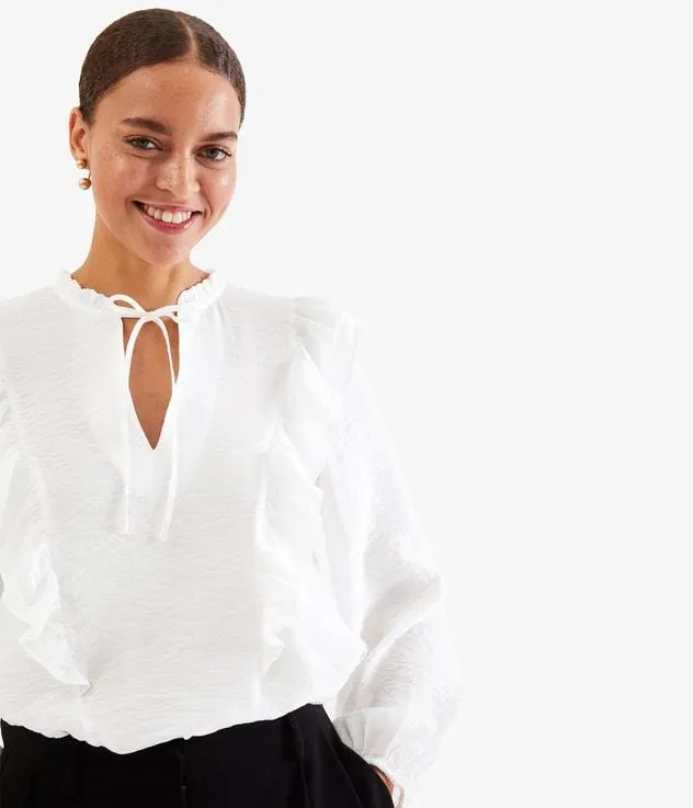 Blus med volanger