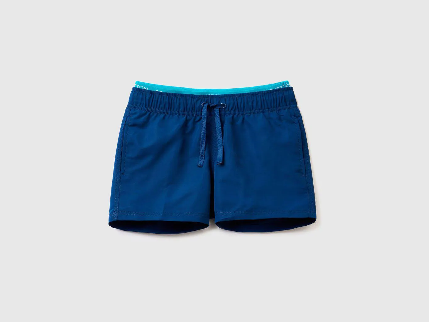 Swim trunks with logoed elastic