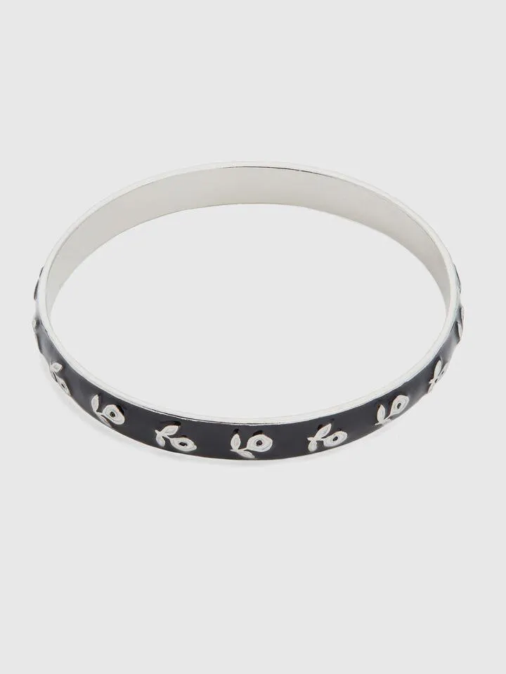 Black bangle bracelet with white flowers