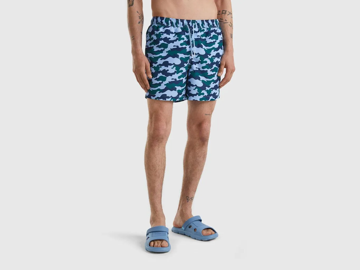 Swim trunks with camouflage print