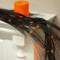 Aritificial Wispy Black Pine Glitter Garland with Orange Lights