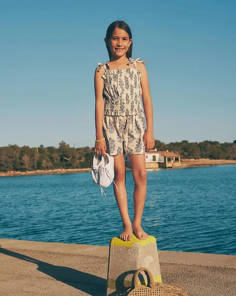 Girls' smocked romper in blooming lilac block print