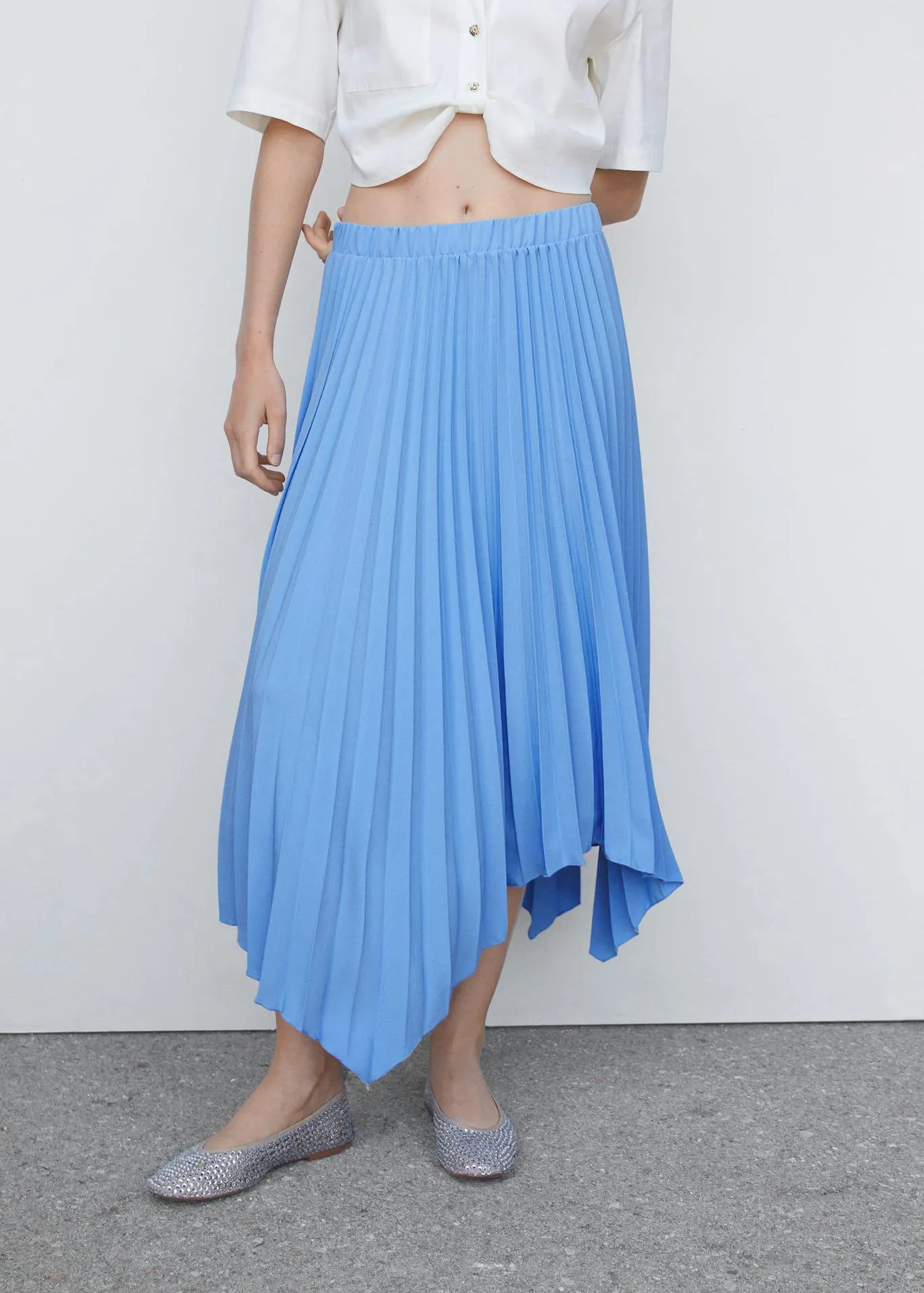 Pleated asymmetric skirt